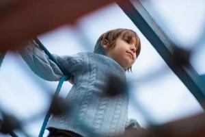 cute little boy having fun in playground photo