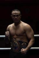 kick boxer with his championship belt photo