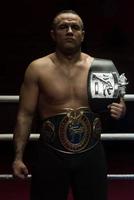 kick boxer with his championship belt photo