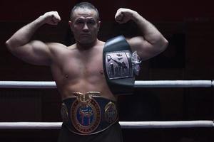 kick boxer with his championship belt photo