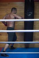 kick boxer training on a punching bag photo