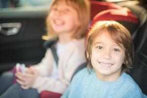 kids  sitting together in modern car photo