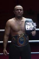 kick boxer with his championship belt photo