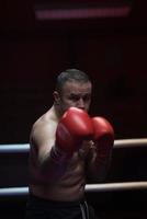 professional kickboxer in the training ring photo