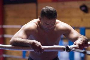 kick boxer resting on the ropes in the corner photo