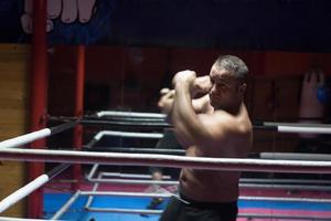 professional kickboxer in the training ring photo