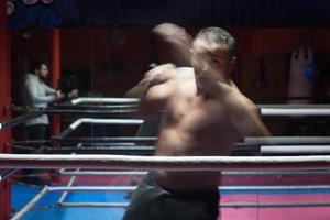 professional kickboxer in the training ring photo