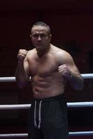 professional kickboxer in the training ring photo