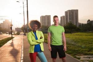 Portrait of romantic pretty couple on fitness session, outside town background photo