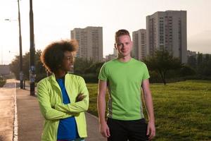 Portrait of romantic pretty couple on fitness session, outside town background photo