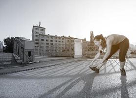 mujer atleta calentando y estirando foto