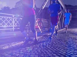 young people jogging across the bridge photo