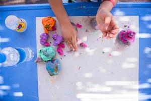 kid hands Playing with Colorful Clay photo