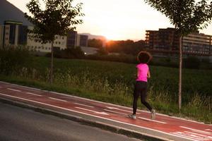 a young African American woman jogging outdoors photo