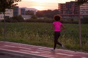 a young African American woman jogging outdoors photo