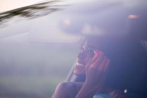 a young African-American woman makeup in the car photo