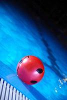 .red ball in swimming pool photo