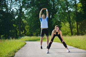 people doing stretching exercise  after jogging photo