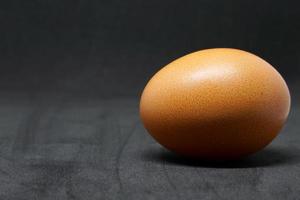 fresh chicken eggs laid out on a black background. photo