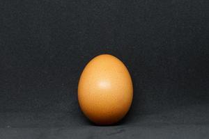 fresh chicken eggs laid out on a black background. photo