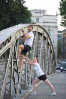 couple warming up and stretching before jogging photo