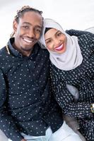 African Couple Sitting On Sofa Watching TV Together photo