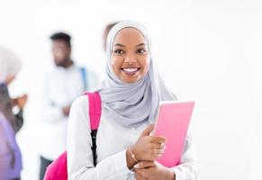 portrait of african female student with group of friends photo