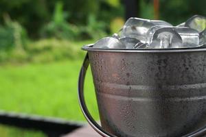 The ice is frozen in a stainless steel tank until it condenses into water droplets. photo