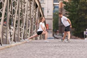 couple warming up and stretching before jogging photo