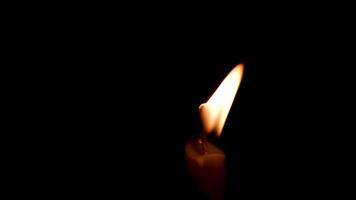 Close-up of the flame burning on the candle with isolated on a black background. Candle flame in the dark. video