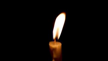 Close-up of the flame burning on the candle with isolated on a black background. Candle flame in the dark. video