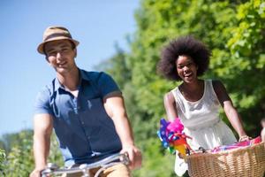 Young multiethnic couple having a bike ride in nature photo