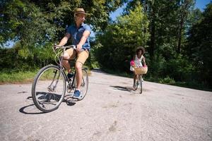 Young multiethnic couple having a bike ride in nature photo