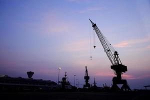 grúas en el muelle al atardecer foto