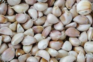 Lots of garlic bulbs on wooden table photo