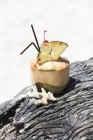 Coconut cocktail on the beach photo