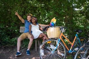 Young multiethnic couple having a bike ride in nature photo