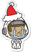 sticker cartoon of a crying astronaut wearing santa hat vector