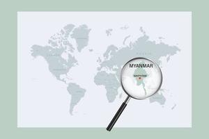 Map of Myanmar on political world map with magnifying glass vector