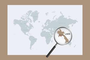 Map of Laos on political world map with magnifying glass vector