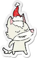 friendly distressed sticker cartoon of a wolf wearing santa hat vector