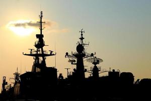 battleship with sunset behind photo