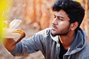 South asian agronomist farmer inspecting corn field farm. Agriculture production concept. photo