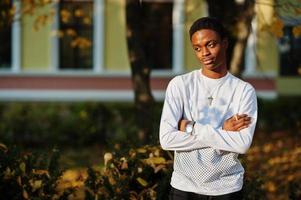 African man posed at the streets of an ancient city in auttumn sunny day. photo