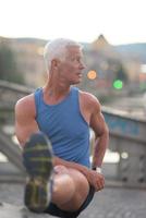 handsome man stretching before jogging photo