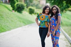 Two african american girls posed outdoor at park patch. photo