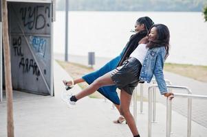 Two african american dark skinned friends female. One of them plus size model, second slim. Having fun and spending time together. photo