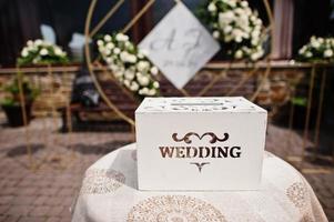 Wooden wedding box for money in table. photo