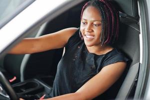 Portrait of young african american woman driving a car. photo