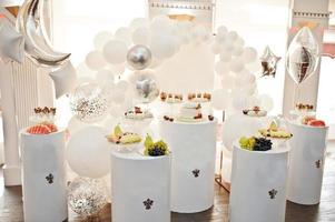 Candy bar decoration setup with delicious cakes and sweets. photo